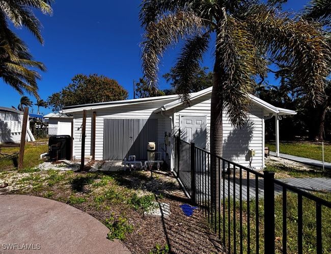 View of side of structure featuring entry for storage and laundry | Image 22