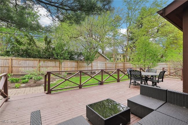 Wooden deck featuring outdoor dining space and a fenced backyard | Image 35