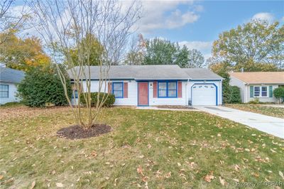 Single story home featuring a garage and a front yard | Image 3