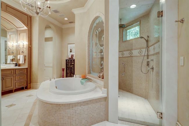 Primary bathroom with jetted tub and waterfall filler and walk in shower. | Image 23