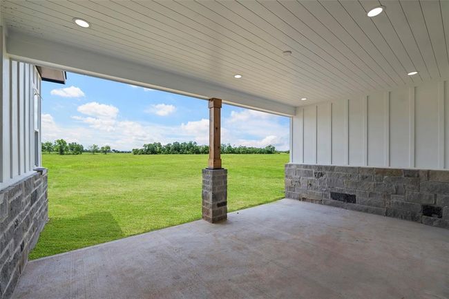 Charming covered back patio perfect for outdoor relaxation and entertaining. | Image 45