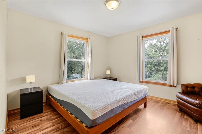 Bedroom with light wood-style floors and baseboards | Image 27