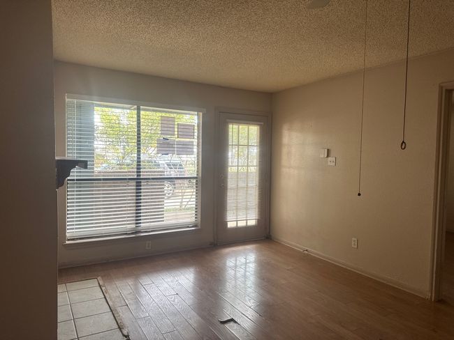Spare room featuring wood finished floors and a textured ceiling | Image 5