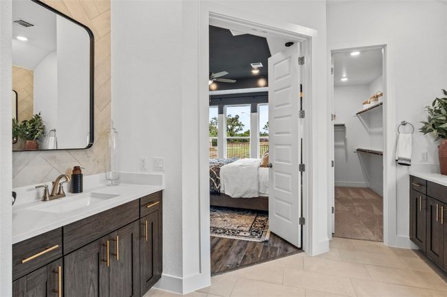 Full bath with vanity, tile patterned floors, ceiling fan, a walk in closet, and ensuite bath | Image 14