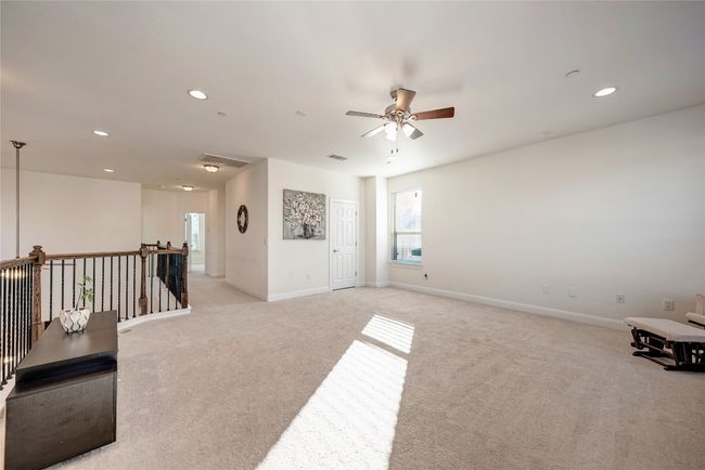 Unfurnished room with light colored carpet, ceiling fan, baseboards, and recessed lighting | Image 11