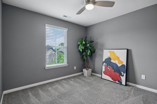 BR 3 overlooks the front of the home. It features a ceiling fan and walk in closet. | Image 27
