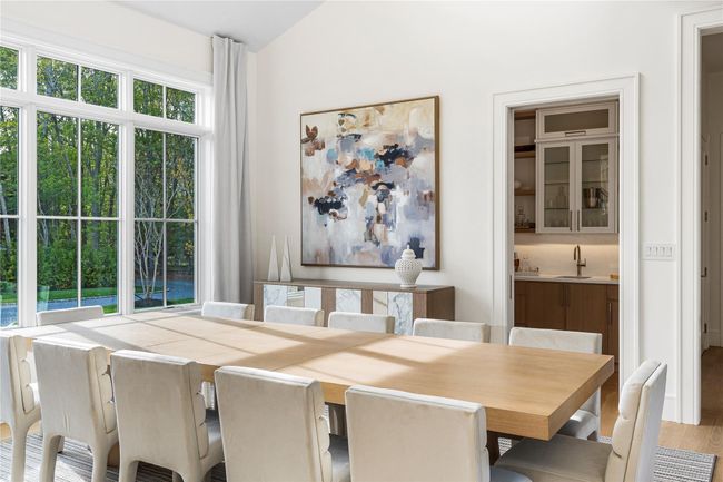 Dining area featuring wood finished floors and lofted ceiling | Image 9
