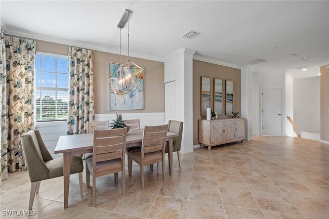Dining space featuring a chandelier, visible vents, and ornamental molding | Image 20