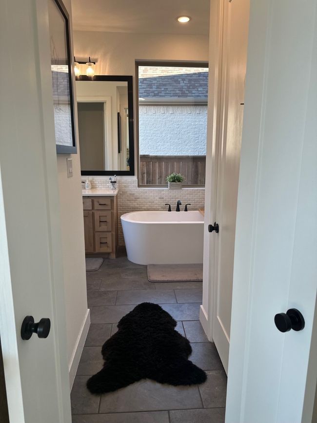 Full bath with a freestanding tub and vanity | Image 20
