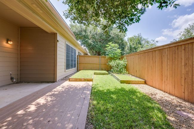 Fenced backyard with a deck and a garden | Image 36