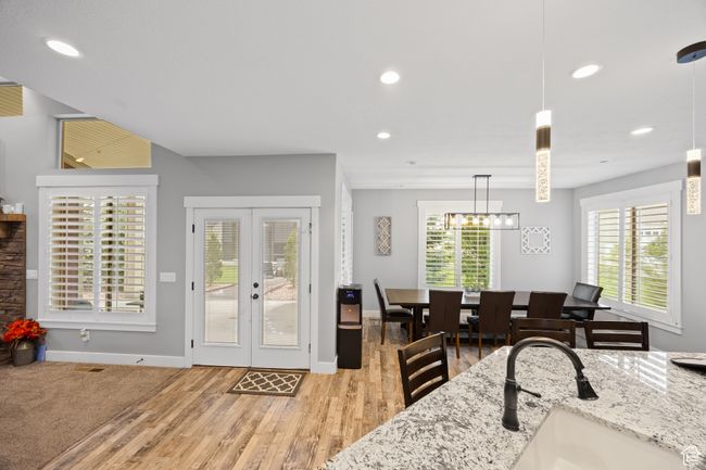 Dining room with french doors, light wood-type flooring, recessed lighting, baseboards, and a chandelier | Image 8