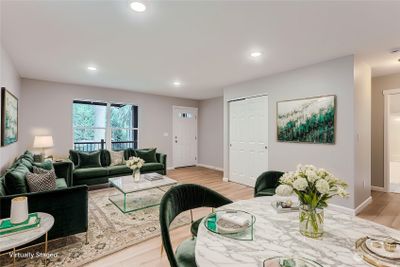 Virtually staged entry and family great room. | Image 3