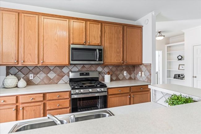 The kitchen offers ample cabinetry. | Image 10