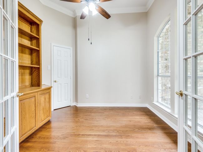 This home office is located at the front of the house and has a great view of the tree covered front yard. | Image 7