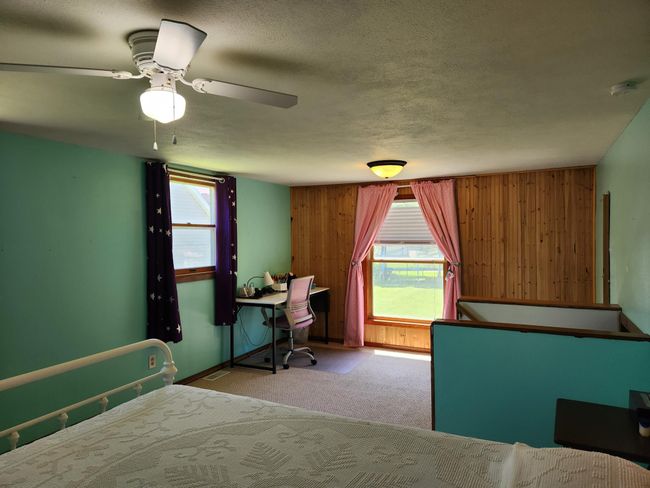 This bedroom also overlooks spacious back yard. | Image 14