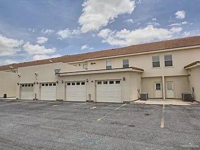 View of front of property featuring a garage and central AC | Image 25