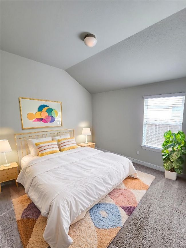 Bedroom with lofted ceiling and carpet floors | Image 23
