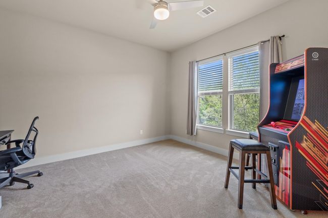 Carpeted office with visible vents, a ceiling fan, and baseboards | Image 34