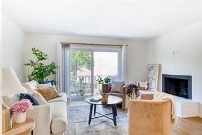 Living area featuring wood finished floors and a fireplace | Image 5