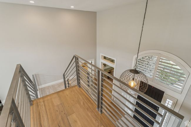 Stairway with wood finished floors, recessed lighting, and a high ceiling | Image 40