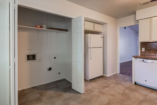 Washroom featuring hookup for an electric dryer, gas dryer hookup, washer hookup, visible vents, and laundry area | Image 11