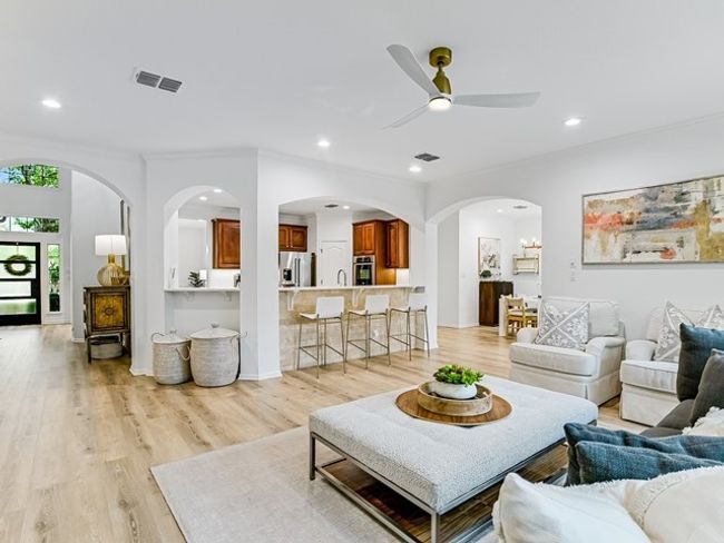 Living room with crown molding, a ceiling fan, visible vents, light wood-style floors, and recessed lighting | Image 6