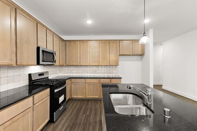 This beautiful brand new kitchen boasts stunning cabinetry that stretches to the ceiling, offering both style and ample storage for all your culinary treasures. | Image 7