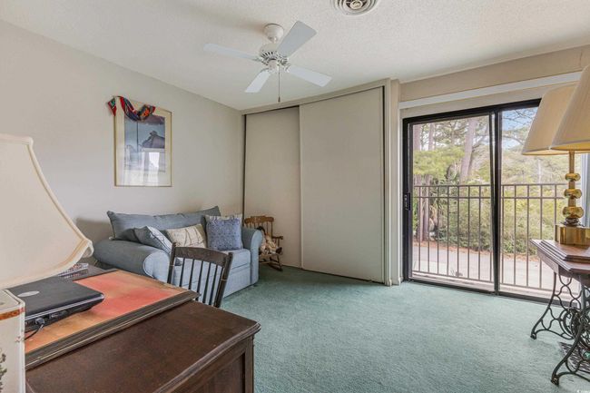 Home office with visible vents, ceiling fan, carpet, and a textured ceiling | Image 19