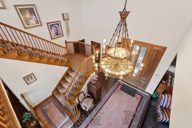 Entrance foyer with a towering ceiling and a chandelier | Image 9