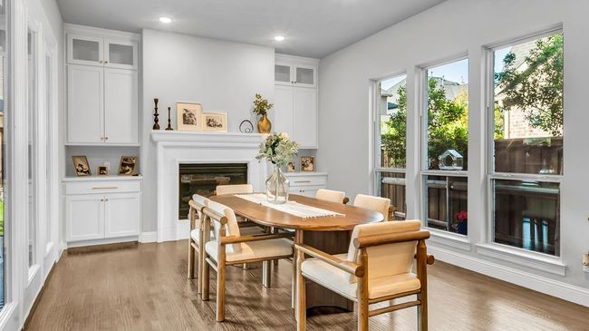 Dining space featuring recessed lighting, a glass covered fireplace, and built ins. | Image 8