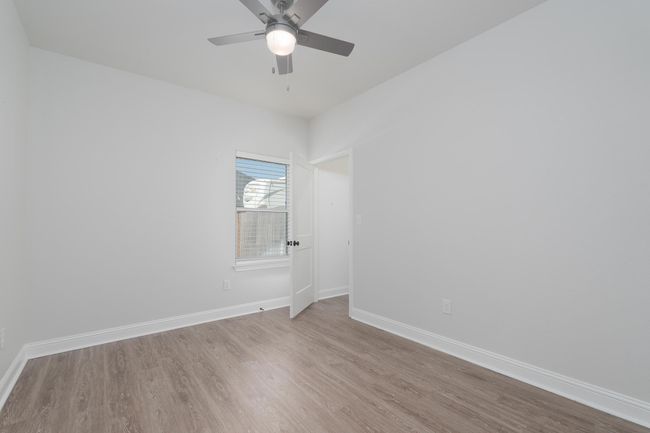 Unfurnished room with wood finished floors, ceiling fan, and baseboards | Image 27