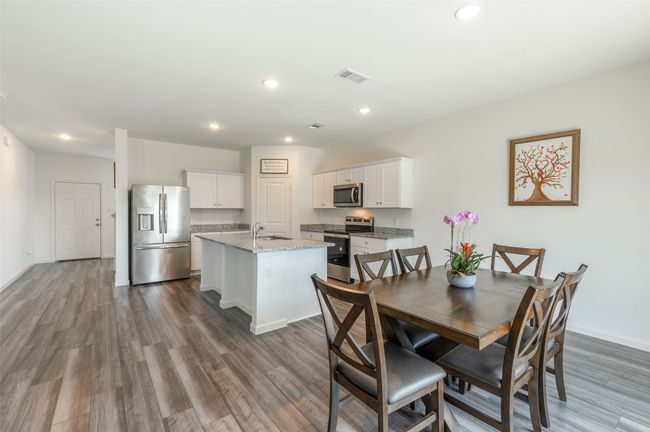Dining room featuring dark wood-style flooring, recessed lighting, and baseboards | Image 11