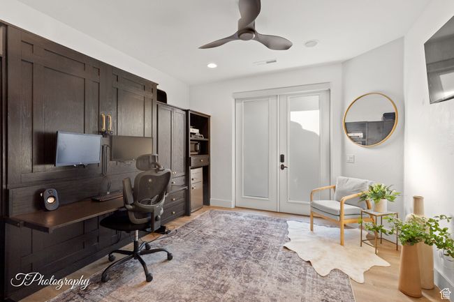 Office area featuring light wood-style flooring, a ceiling fan, and recessed lighting | Image 13