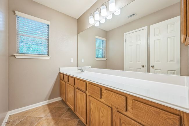 Bathroom featuring visible vents, vanity, baseboards, and a healthy amount of sunlight | Image 19