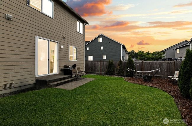 Spacious backyard with privacy fencing, ideal for entertaining or play. | Image 24