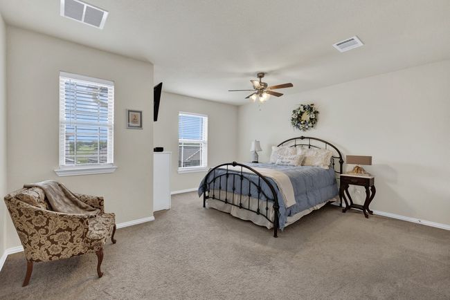 Bedroom with visible vents, baseboards, and carpet floors | Image 27