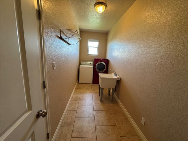 Entryway with washer and dryer, a textured ceiling, and a textured wall | Image 18