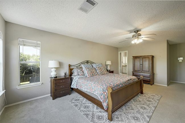 Bedroom featuring light carpet, a textured ceiling, and ceiling fan | Image 20