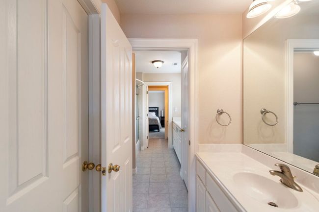 Bathroom featuring vanity, tile patterned floors, and ensuite bath | Image 32