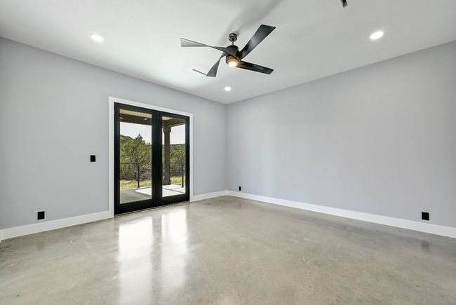 This home offers 5 bedrooms total including this secluded main floor primary suite with walkout access to the back porch. | Image 19
