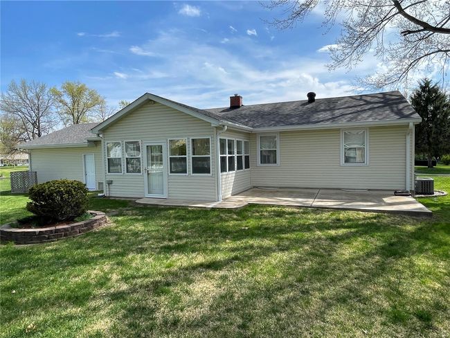 Back of house with a lawn, cooling unit, roof with shingles, and a patio | Image 44