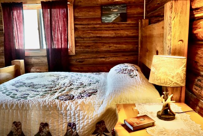 Main Floor Bedroom featuring log walls | Image 29