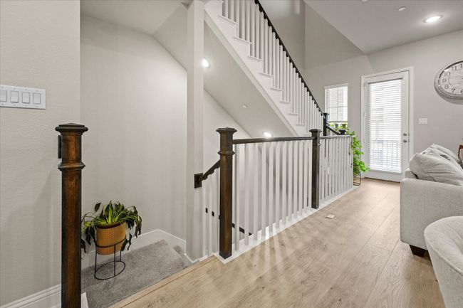 Staircase with wood finished floors and recessed lighting | Image 29