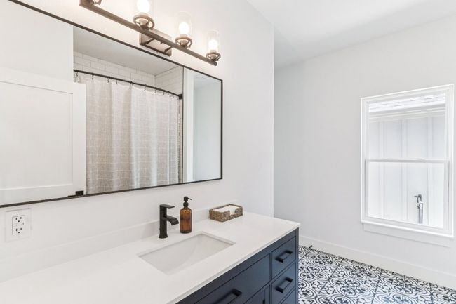 Bathroom featuring vanity and a shower with shower curtain | Image 26