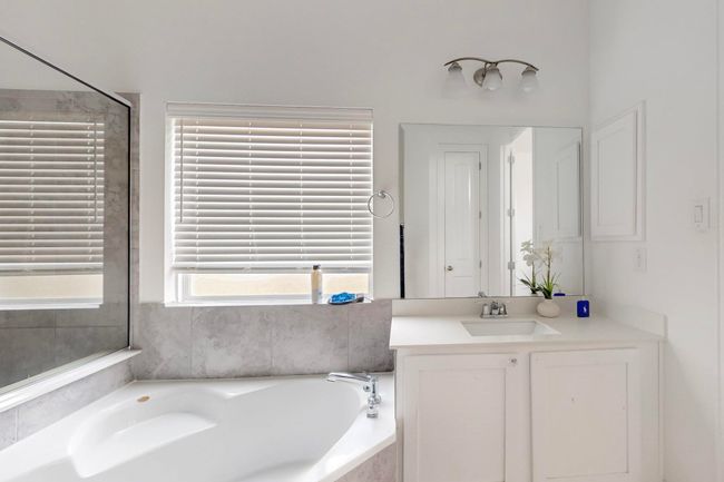 Bathroom with a bath and vanity | Image 18
