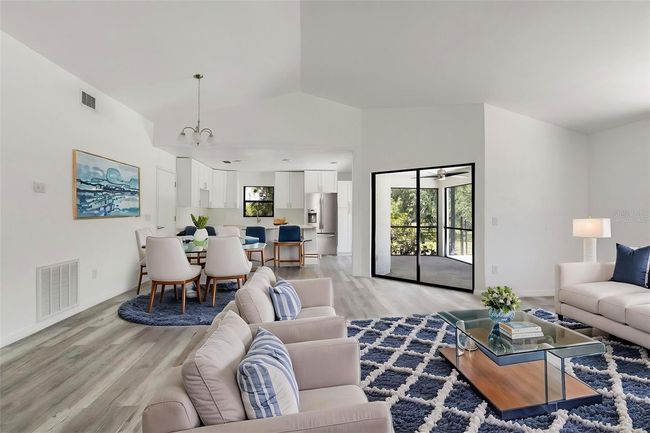Virtually Staged: Bright, open living area with new floors and fresh paint throughout. | Image 4