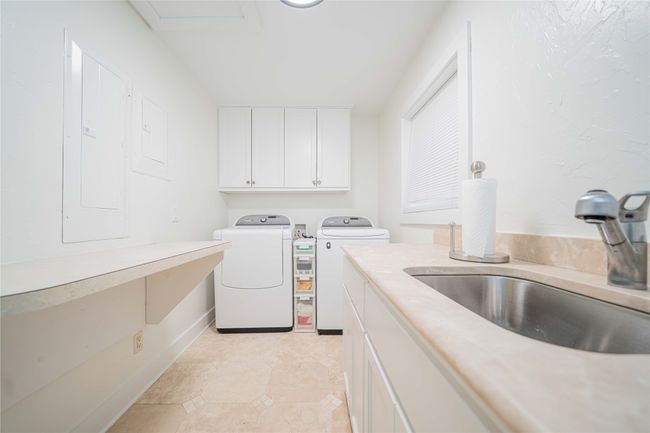 Laundry area featuring cabinet space and washer and dryer | Image 29