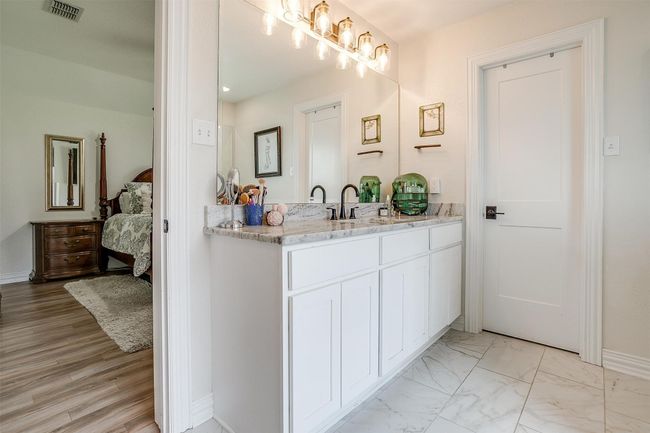 Ensuite bathroom featuring vanity and marble look tiles | Image 24