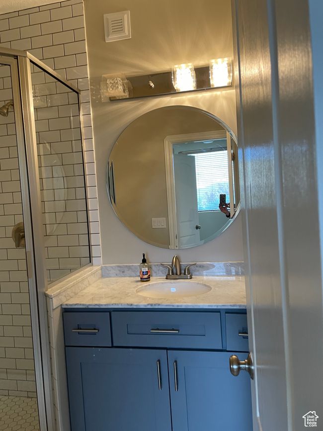 Bathroom featuring a shower stall and vanity | Image 22