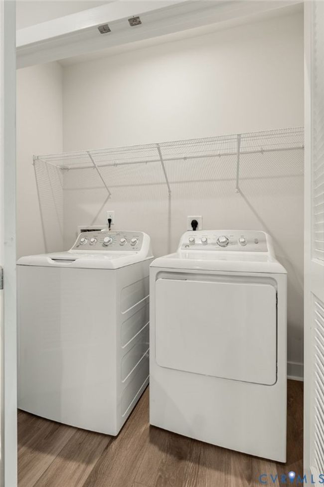 Washroom with washer and dryer and wood finished floors | Image 21